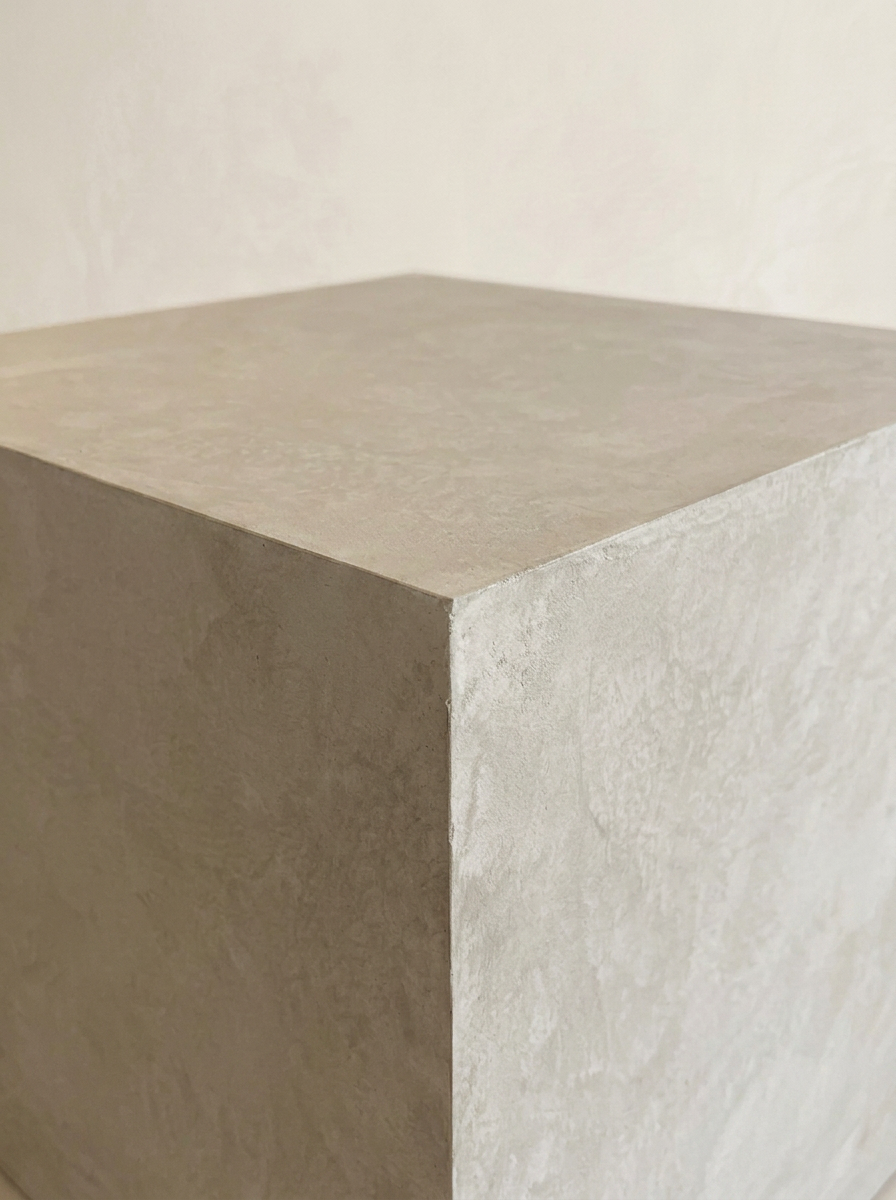 Close detail of the trowelled corner edge of the microcement cube side table