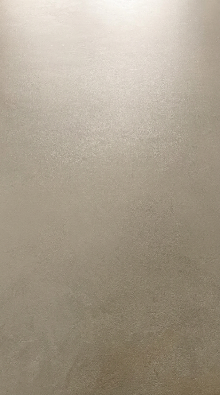 Grey microcement surface showing fine mottled texture
