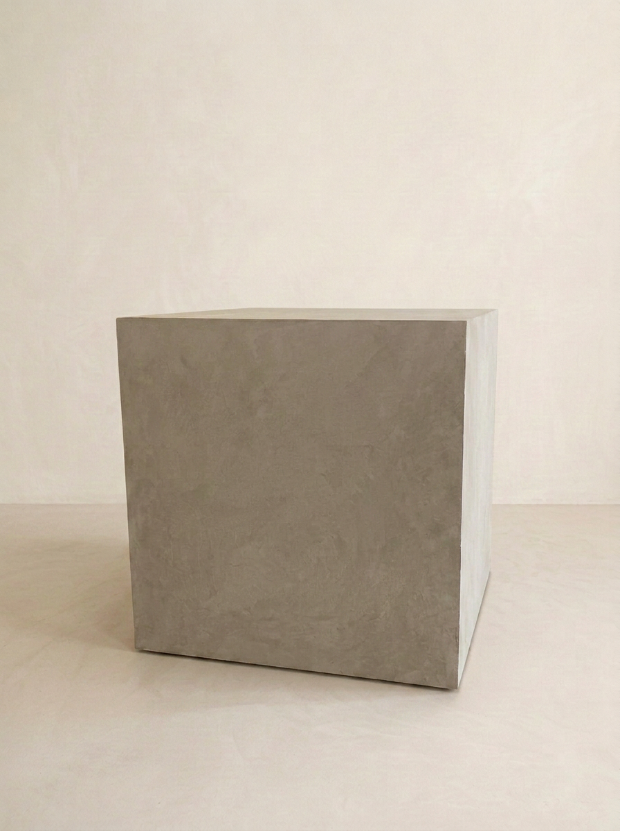 Near-frontal view of the grey microcement cube side table
